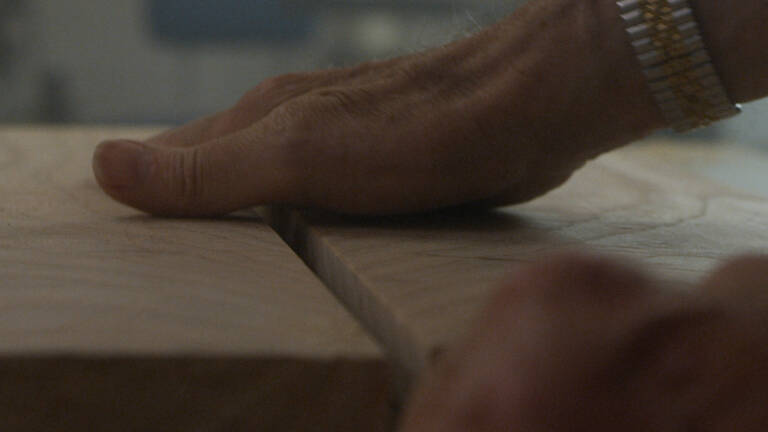 A Craftsmans hand on wood Desktop