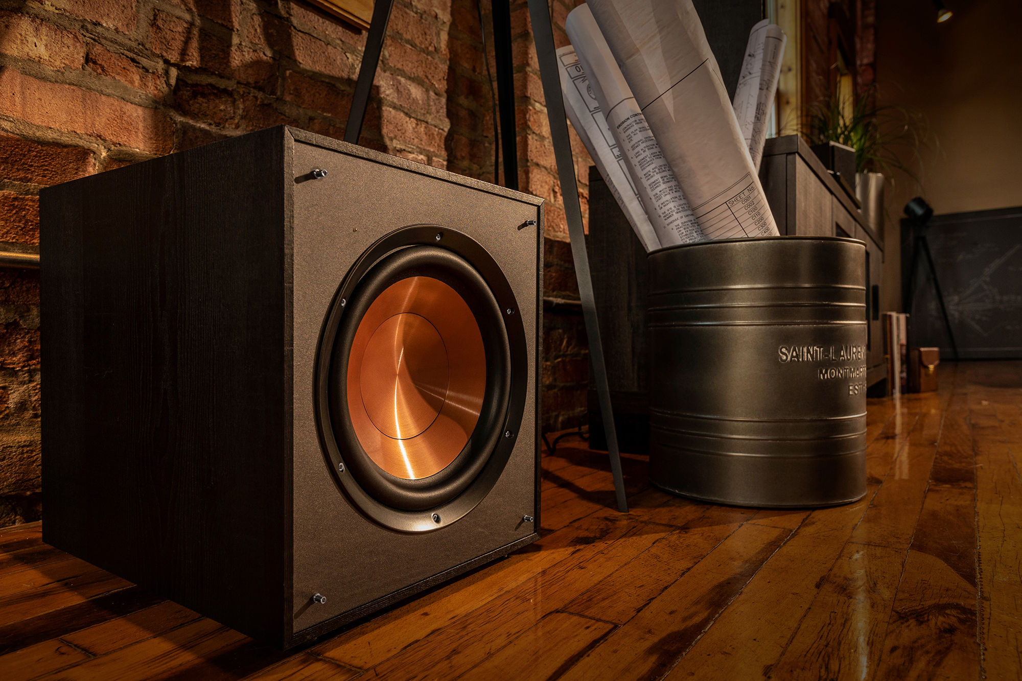 Subwoofer next to a bucket of blueprints