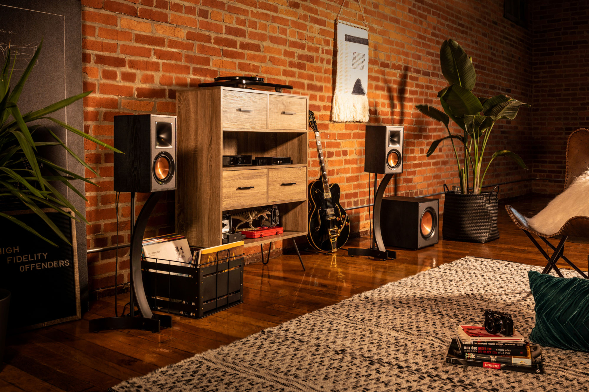 Klipsch speakers with a guitar and wooden shelf